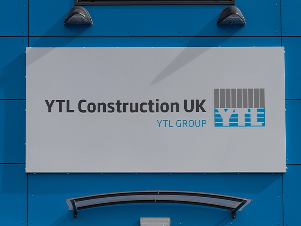 YTL Construction UK sign on the outside of a blue building