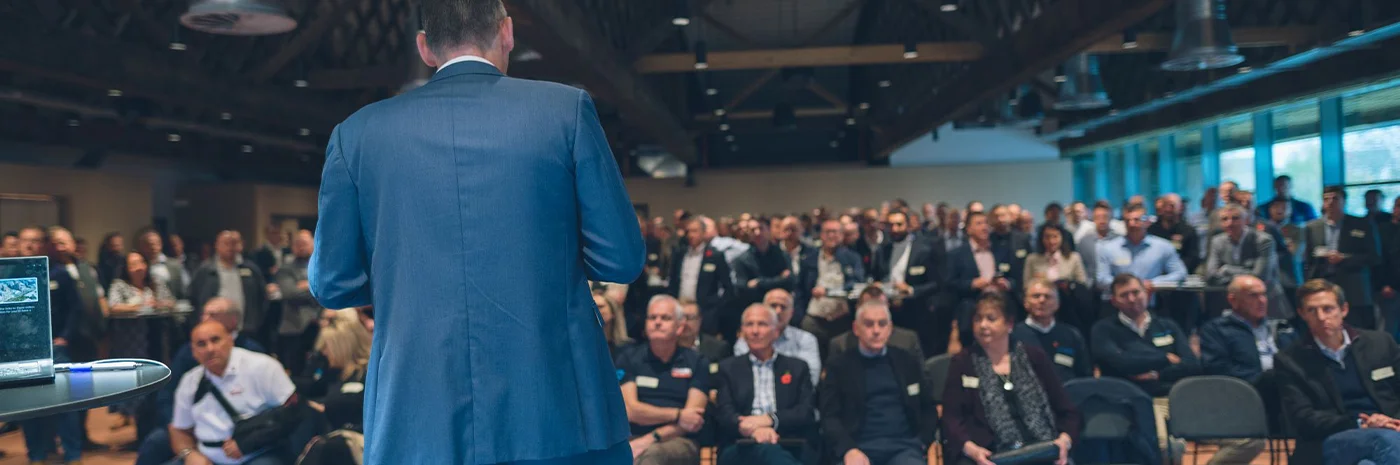 Speaker in front of an audience talking at a networking event